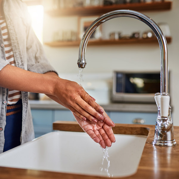 A Woman Washing Her Hands in a Kitchen Sink in Atlanta, GA