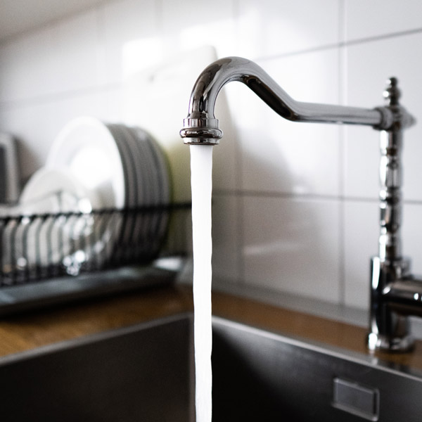 A Close-up View of the Kitchen Sink Running Showcasing Frozen Pipe Repair in Atlanta, GA