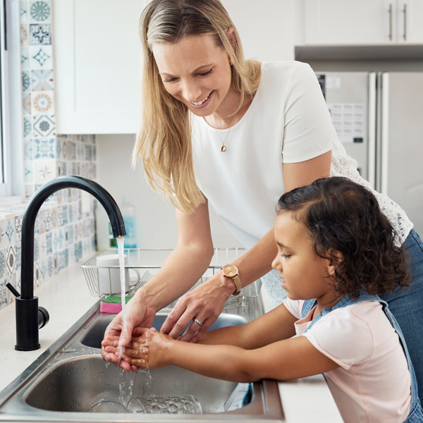 A Mother Assists Her Daughter in Washing Their Hands at a Kitchen sink in Atlanta, GA