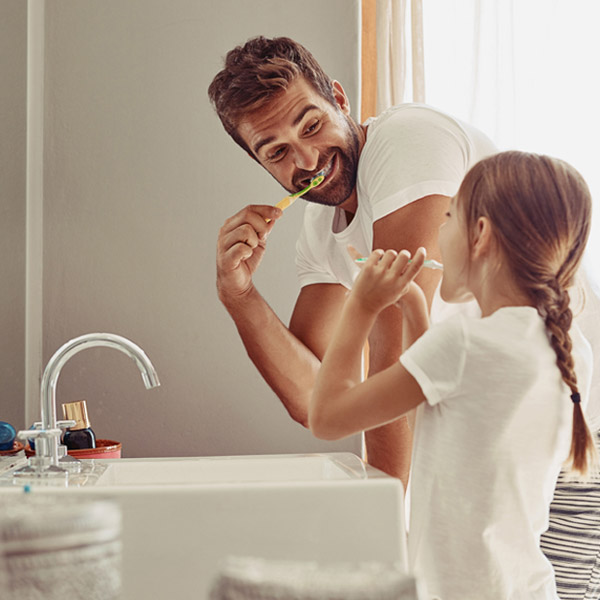 Dad and daughter brushing their teeth in Atlanta, GA.