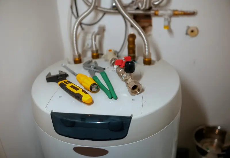 Plumbing tools on a water heater in Metro Atlanta