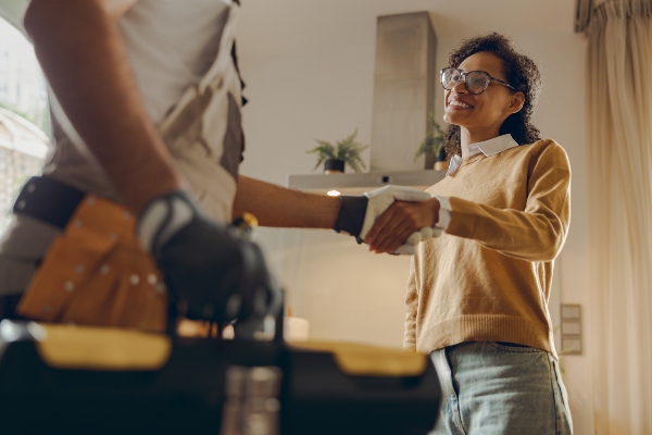Woman shaking hands with plumber
