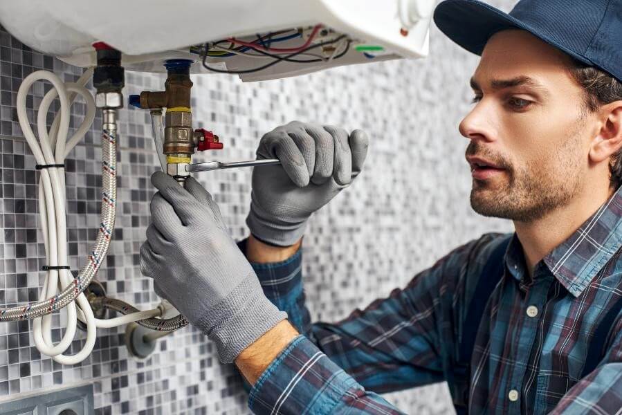 A Technician Performing Water Heater Repair at a Residential House in Marietta, GA
