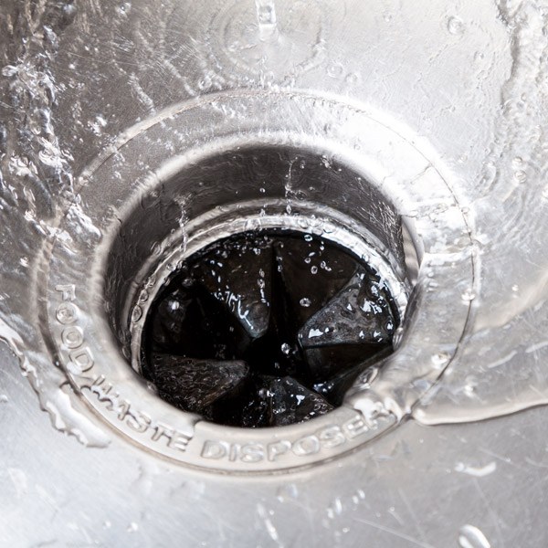 Water flowing from the sink symbolizes commercial garbage disposal repair in Atlanta, GA.