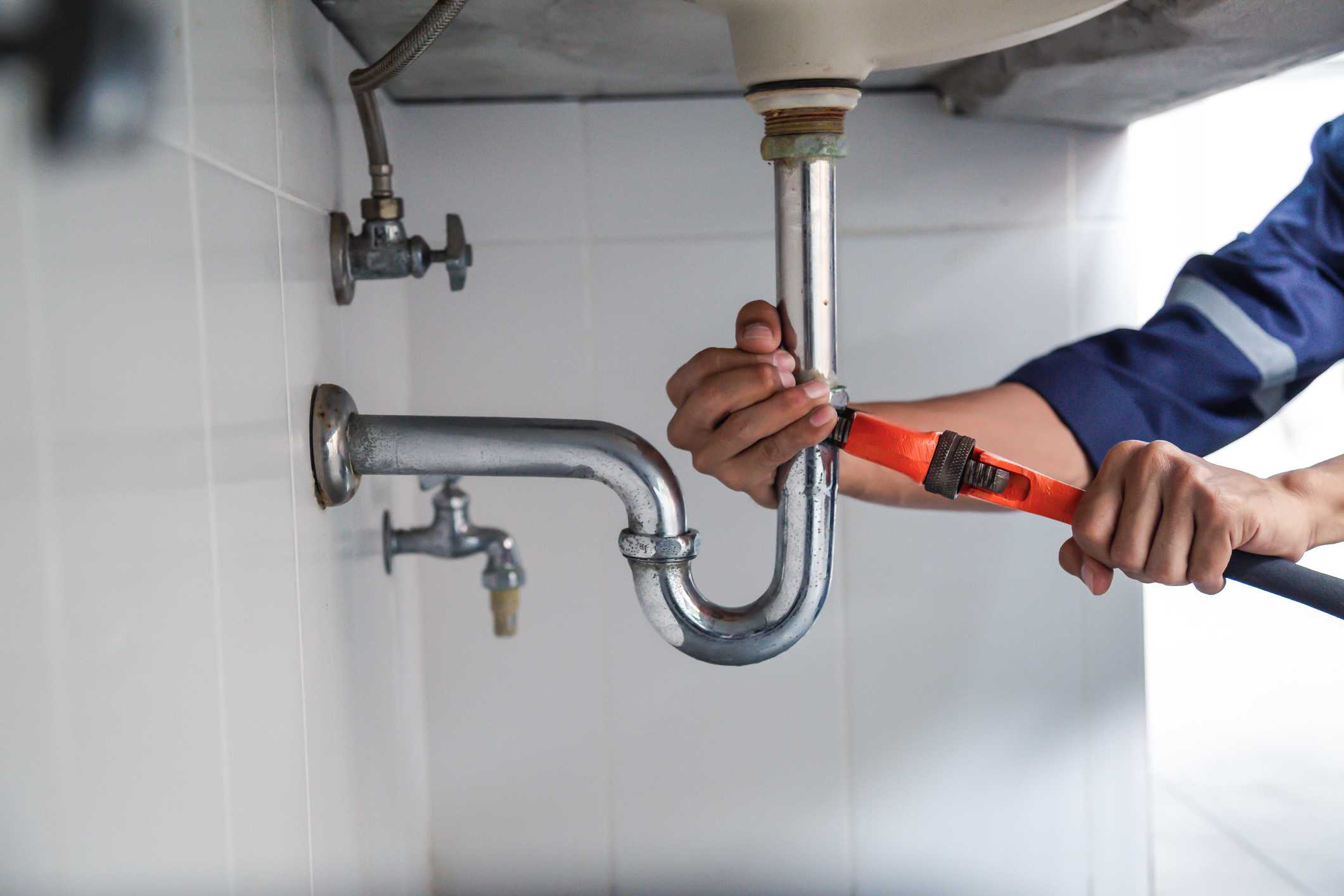 A Technician is Tightening the Drain Pipe with a Tool in Powder Springs, GA