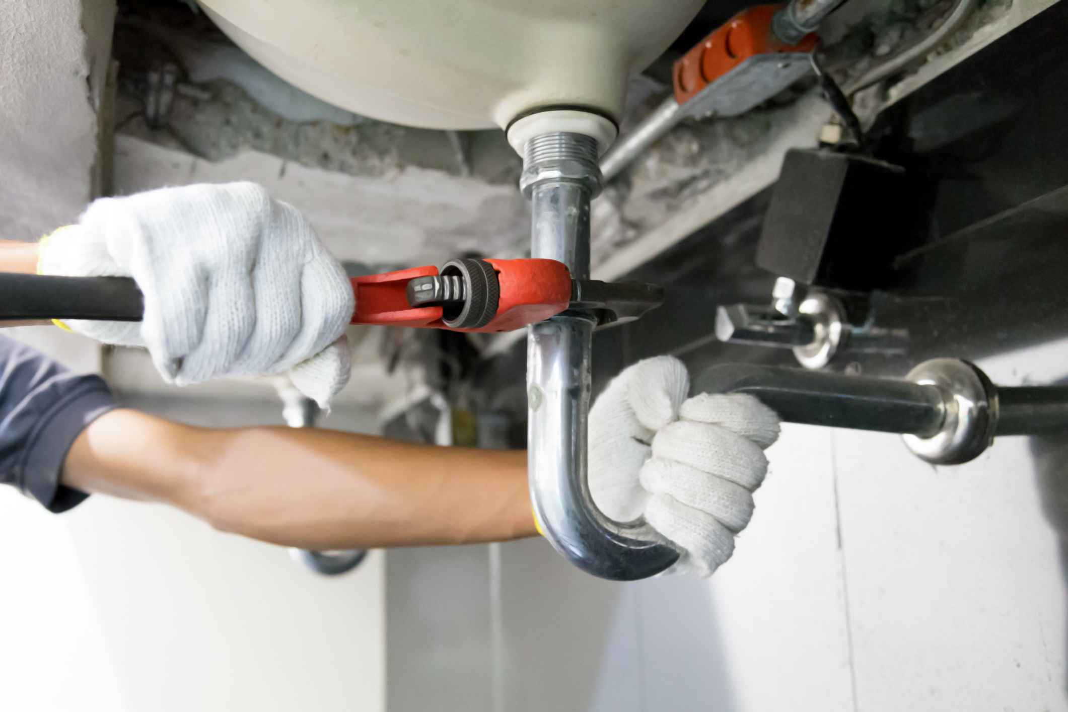 A team member of Quick Action Plumber is repairing the sink pipe with the tool in Hiram, GA.