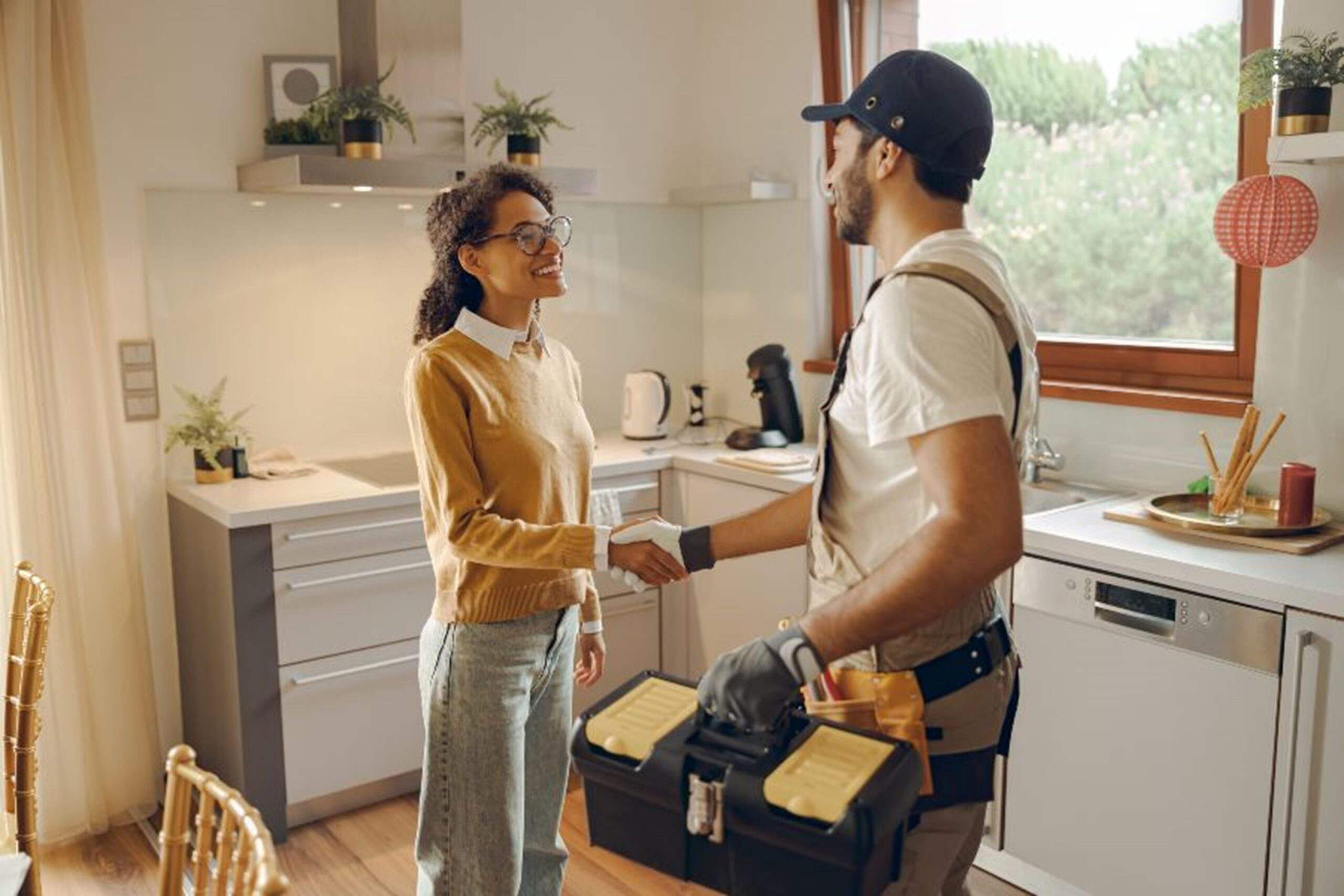 A plumber is shaking hands with a client after providing plumbing service in East Cobb, GA.